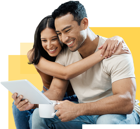 smiling couple looking at tablet