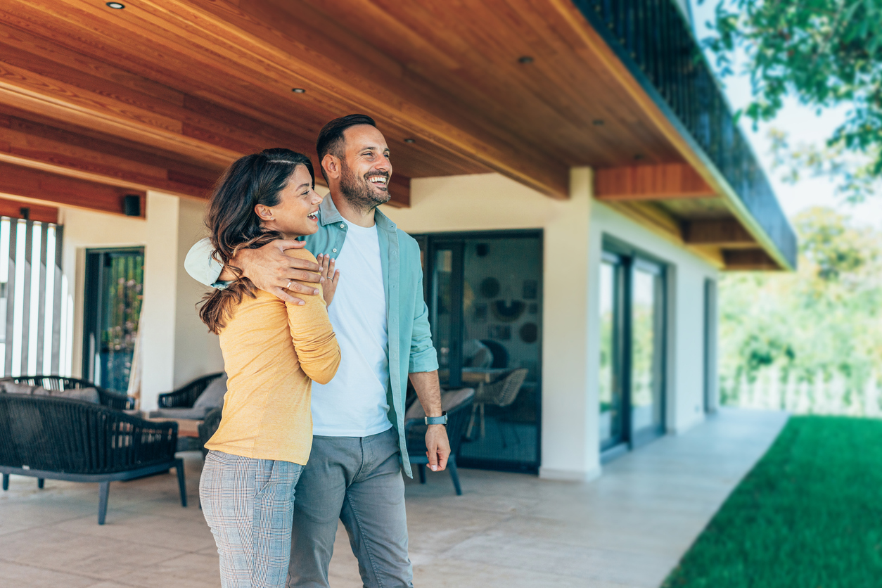 Embraced couple in front of their new house Homeowners, Renters, and the Property Signals Brands Can’t Ignore in 2026