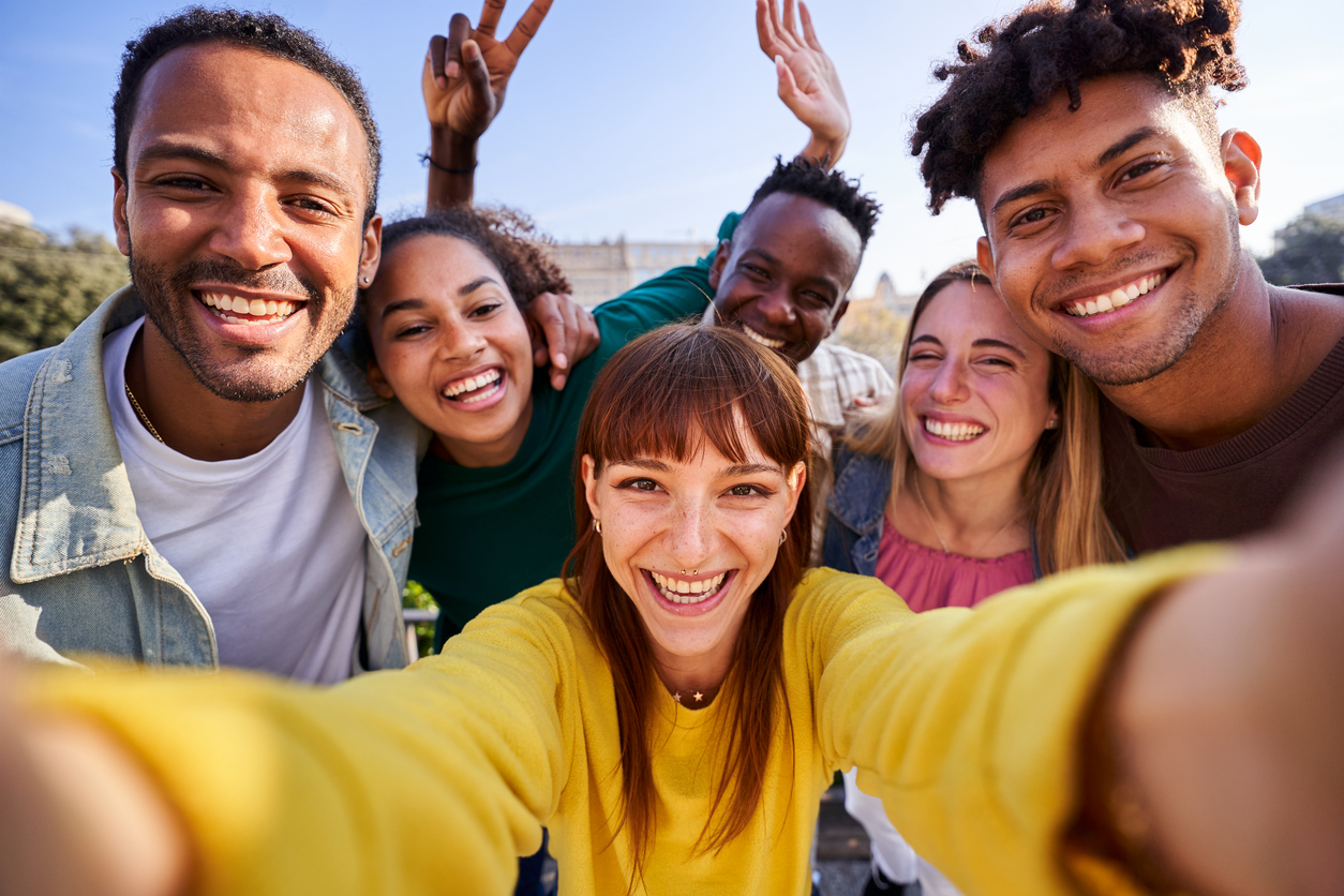 Multiethnic group of friends taking a selfie outdoors, having fun in sunny day. Younger Generations Are Gaining Spending Power