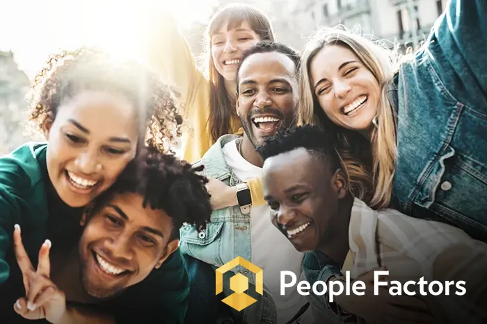 people-factors-group-of-friends-laughing-iStock-1451821587 multiracial group of friends laughing and posing for the camera, with the People Factors logo in the corner