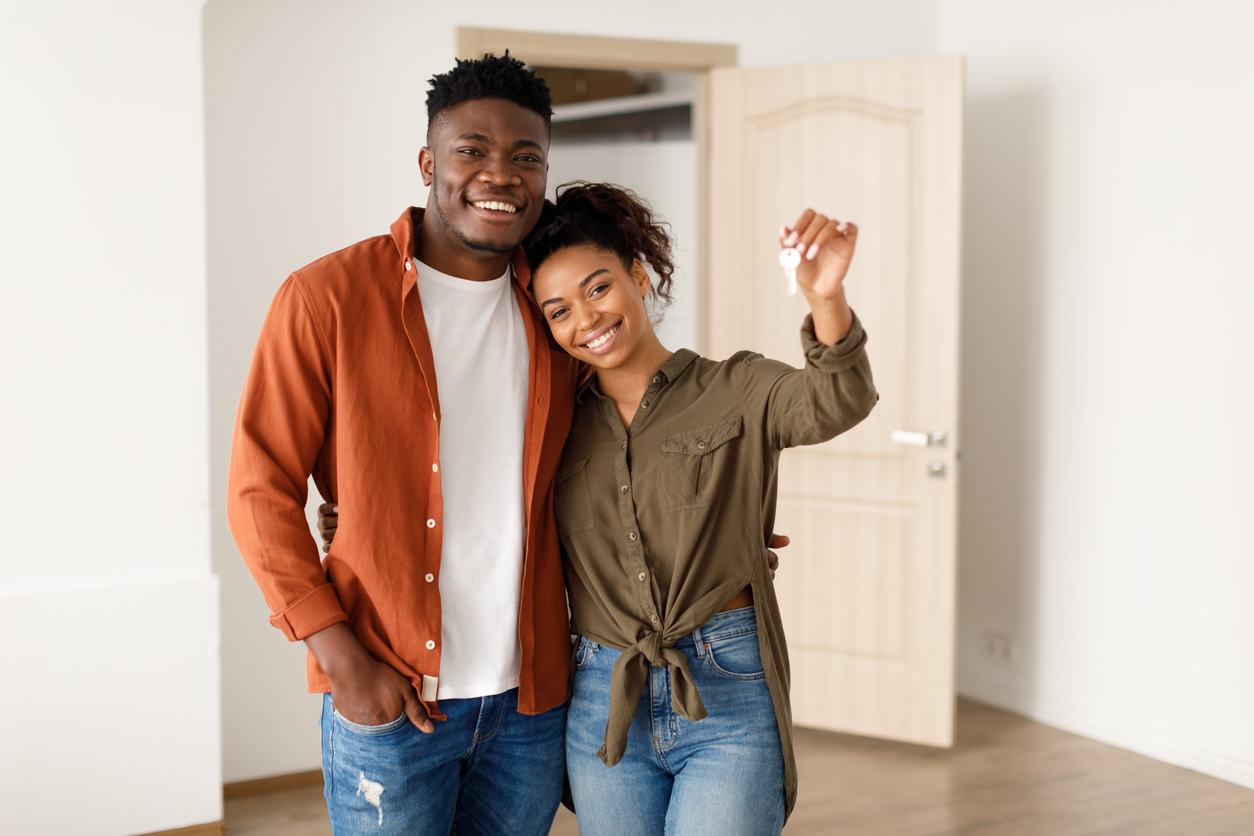 African Spouses Showing House Key Standing Among Moving Boxes Indoor Why Buying a Home Has Become the Ultimate Life Milestone