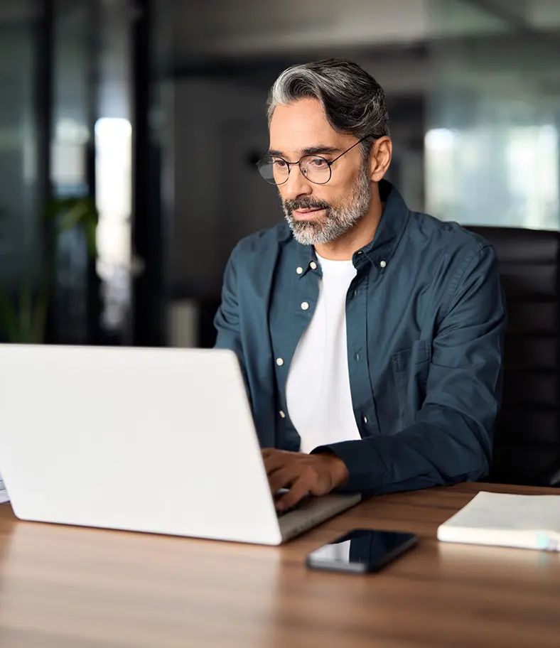 02-man-at-computer-iStock-2257189711 photo of a man working at his laptop