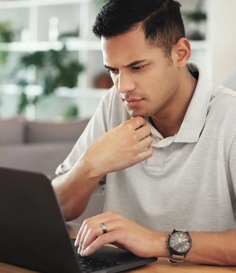 05-man-at-computer-iStock-1487250536 photo of a man working at his laptop