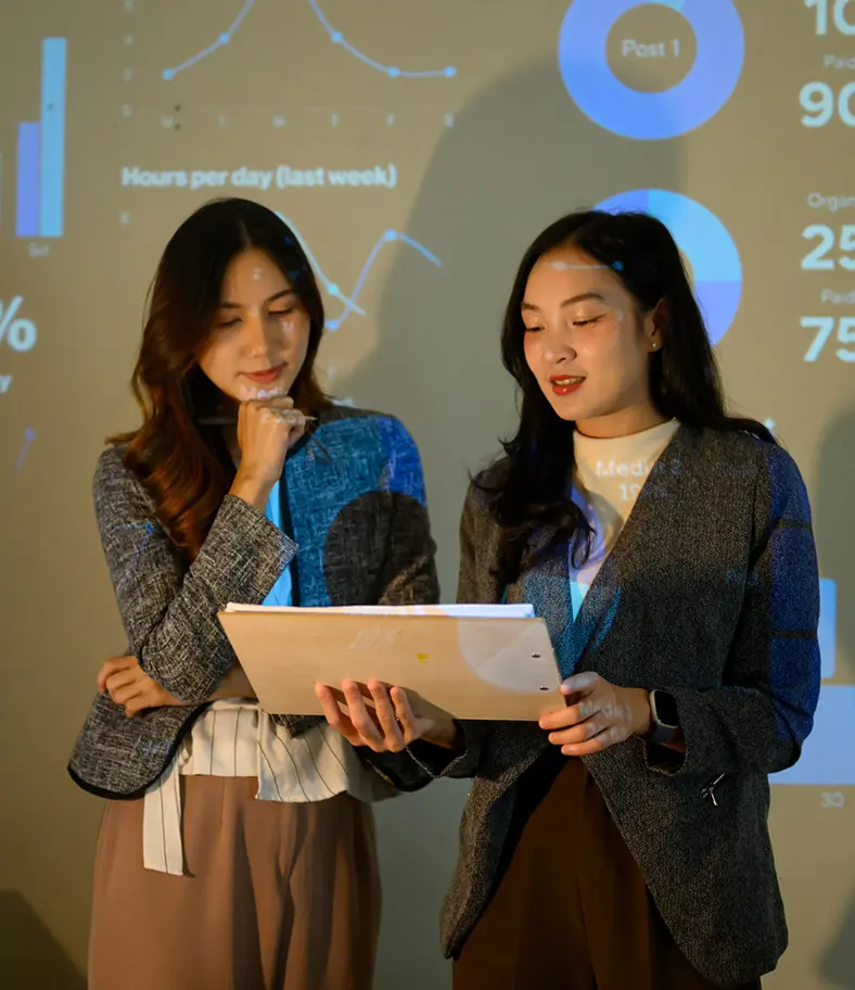 06-women-reviewing-documents-iStock-2287132997 photo of two young businesswomen reviewing a document together