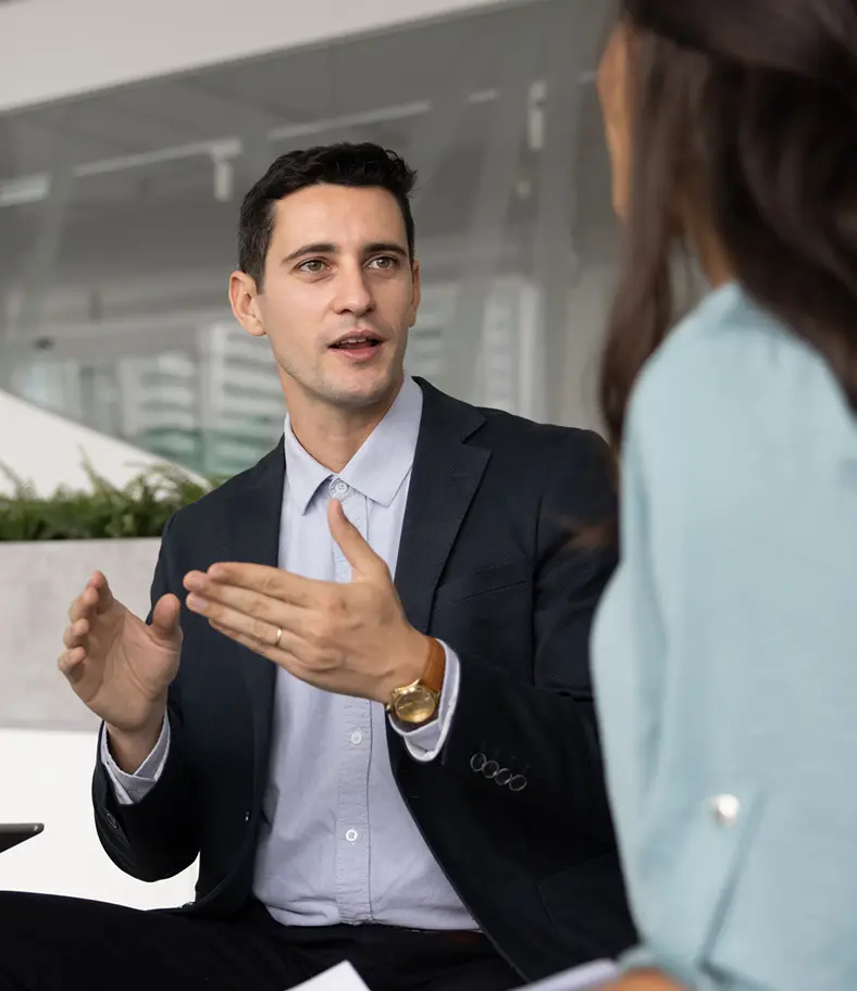 11-business-people-chatting-iStock-2232987818 photo of two business colleagues chatting