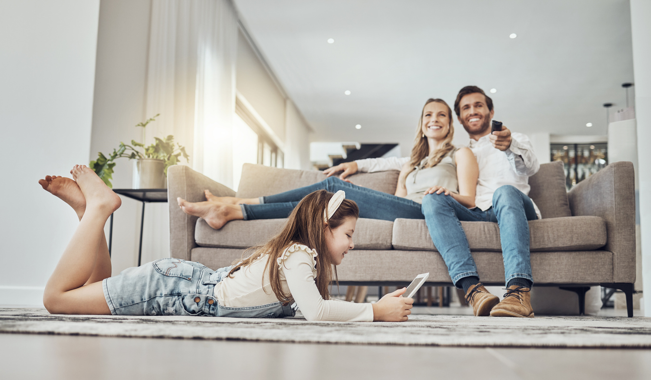 Happy family, relax or child on tablet in living room, house or home live streaming, movies channel or internet show bonding. Smile, parents or kid girl on technology, television or watching tv media in-market intent data